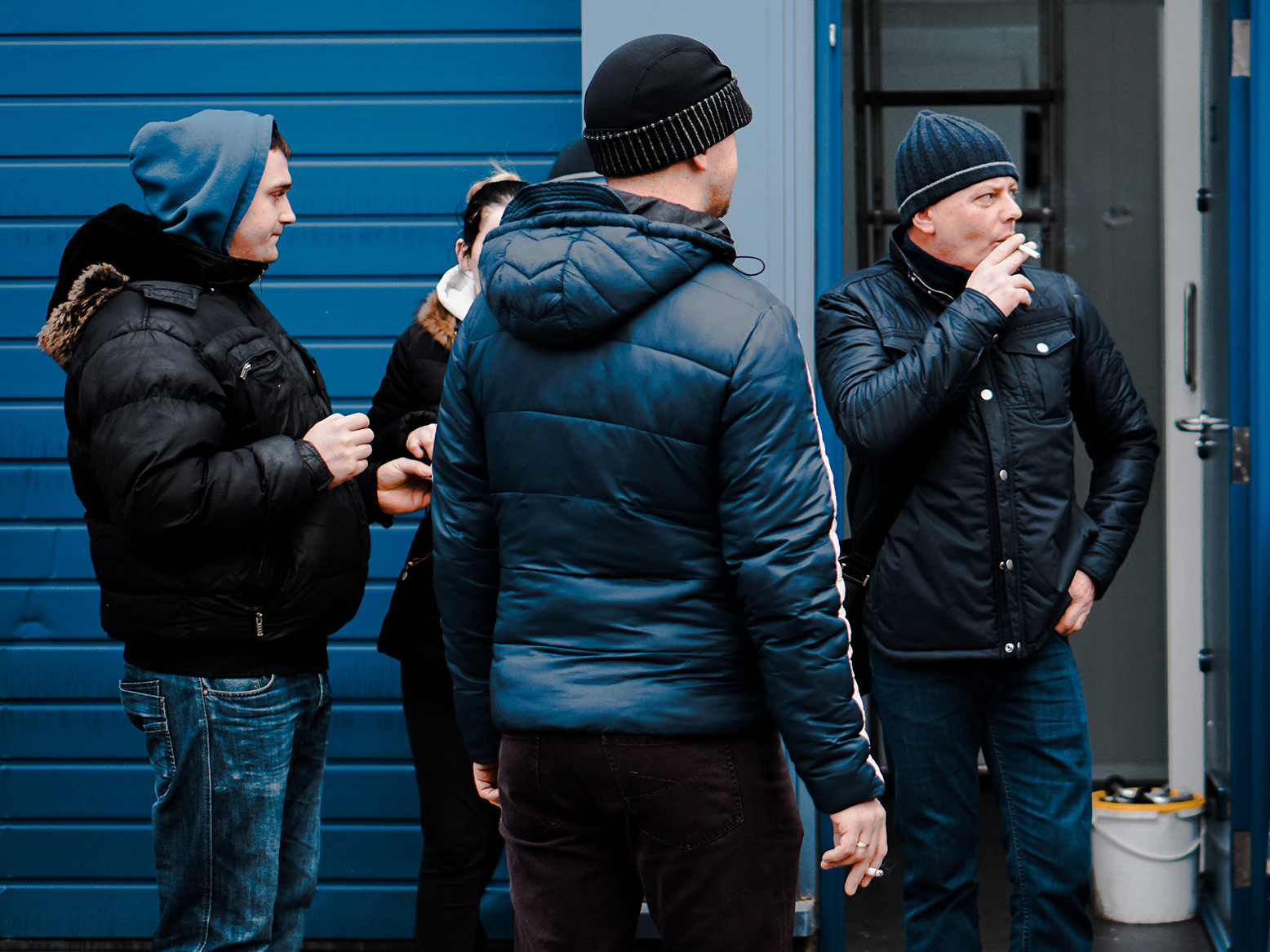 Men in a group, smoking